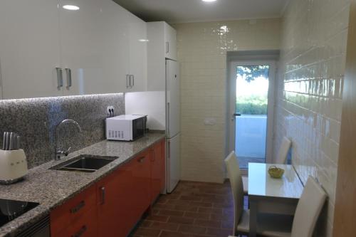 a kitchen with a sink and a counter top at Casa do Livramento in Luz de Tavira