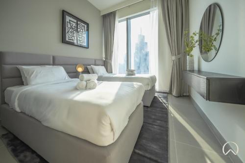 Postel nebo postele na pokoji v ubytování Oraya - 2BR apt in Downtown Blvd with Burj Khalifa views