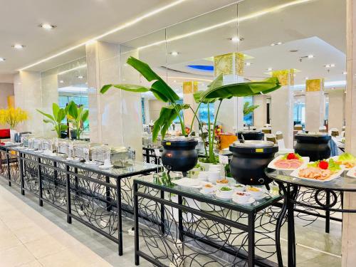 a buffet line with plates of food on tables at Bao Son International Hotel in Hanoi