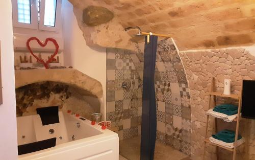 a bathroom with a bath tub and a sink at C'era una volta Relax in Altamura