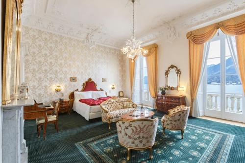 a hotel room with a bed and a table and chairs at Grand Hotel Villa Serbelloni in Bellagio