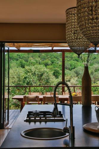 a kitchen with a sink and a counter with a view at Battle Creek Safaris in Derby