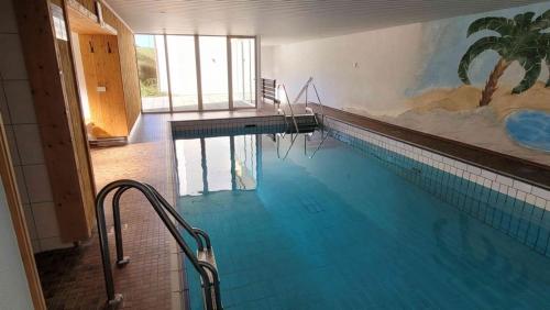 a large swimming pool with a painting on the wall at Appartement Nr 11, Fewo in Oberstaufen-Steibis in Oberstaufen