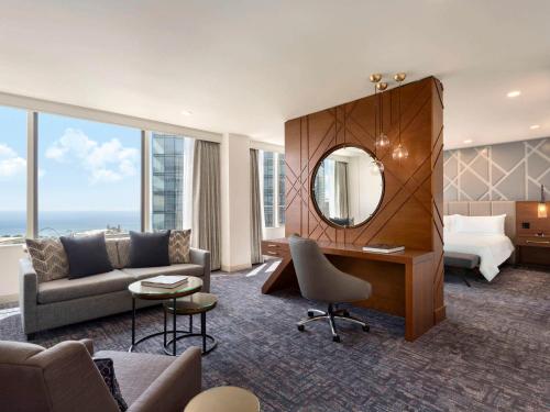 a hotel room with a desk and a bed and a mirror at Swissotel Chicago in Chicago