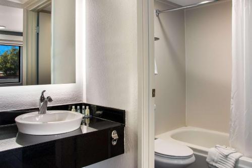 a bathroom with a sink and a toilet and a mirror at Quality Inn Santa Fe New Mexico in Santa Fe