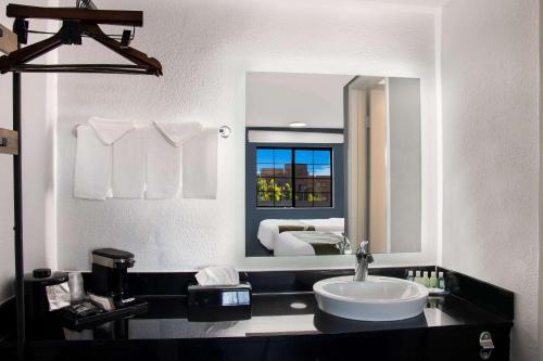 a bathroom with a sink and a large mirror at Quality Inn Santa Fe New Mexico in Santa Fe