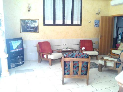 un soggiorno con 2 sedie e una TV di Hotel Celestina a Villapiana