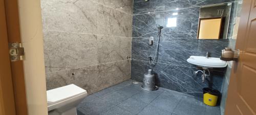 a bathroom with a toilet and a sink at RK COMFORTS in Bangalore