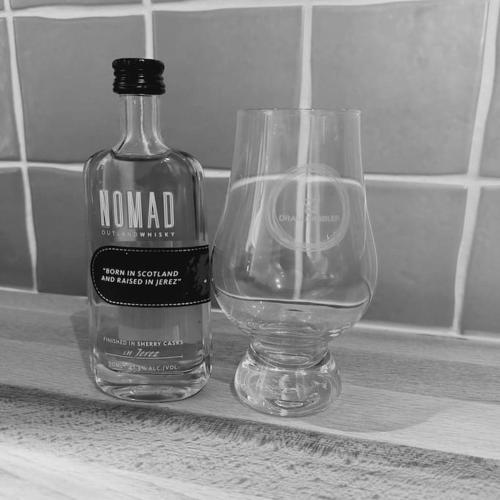 a bottle of alcohol next to a glass on a counter at Crossways Cottage Quirky 2 bedroom cottage in Damdale, Central Peebles in Peebles