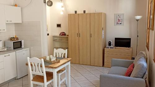 a kitchen and living room with a table and a couch at Cecily's House in Mantova