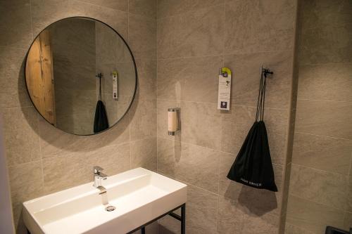 a bathroom with a sink and a mirror at Pure Montagne Resort & Spa in Saint-Martin-Vésubie