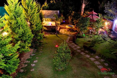 an aerial view of a garden with trees and a house at Sriniketana Homestay in Madikeri