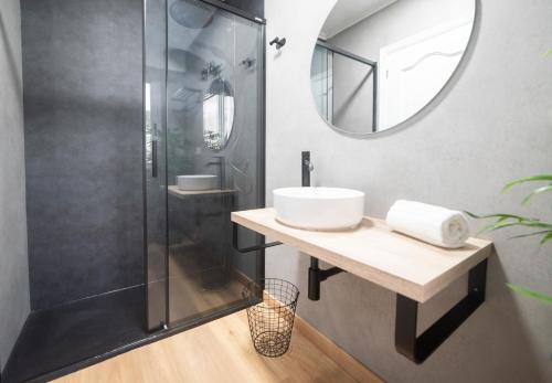 a bathroom with a sink and a shower at Apartamento AN Sol “Ferrol” in Ferrol
