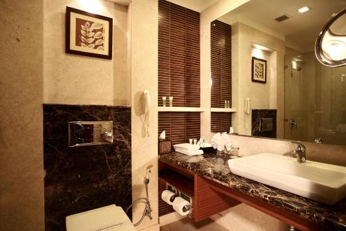 a bathroom with a sink and a mirror at DLF City Club 3 in Gurgaon