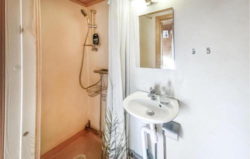 a bathroom with a sink and a mirror at Stuga 2 in Nybro