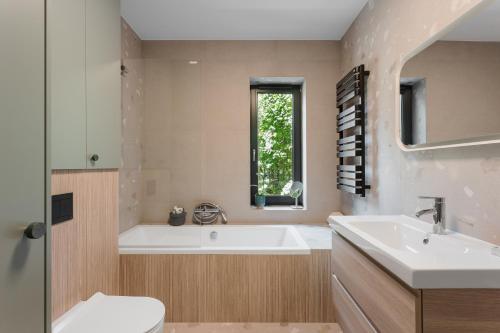 ein Badezimmer mit einer Badewanne, einem Waschbecken und einem WC in der Unterkunft Bukowe Przedmieście in Bielsko-Biała