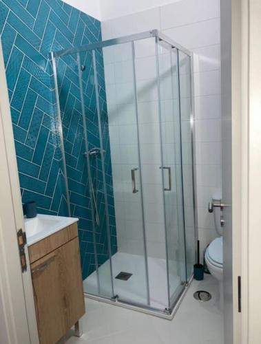 a bathroom with a glass shower with a toilet at Casa do Largo in Bragança