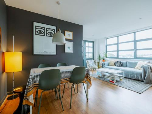 a living room with a table and a couch at Pass the Keys Central Location Flat near Old St and Dalston Overlooking Rosemary Park and Regents Canal in London
