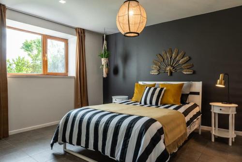a bedroom with a bed with yellow and black stripes at Peaceful countryside retreat in Gauja National Park in Raiskums