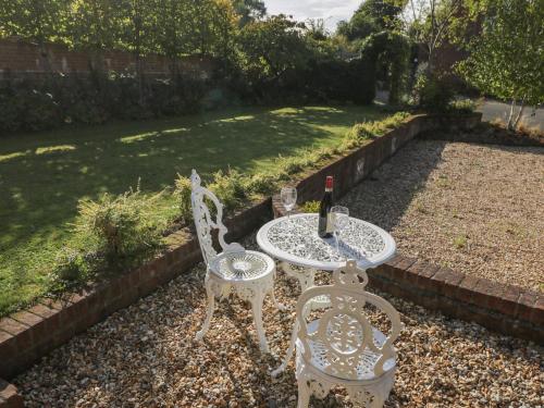 a table and two chairs and a bottle of wine at The DunnitManor Farm in Salisbury