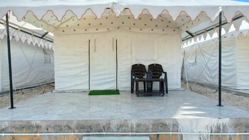 two chairs sitting inside of a white tent at Barkha Desert Safari Camp Sam Sand Dunes Jaisalmer in Sām