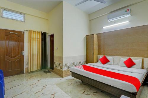 een slaapkamer met een bed met rode kussens erop bij A5 Hotel And Dormitory in Gorakhpur