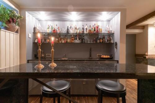 a bar with two stools and a counter with drinks at Reipas Palace in Kotka