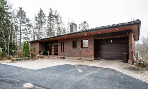 a brick house with a garage and a driveway at Reipas Palace in Kotka