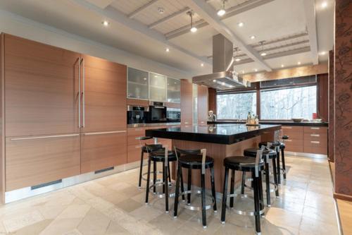 a kitchen with a black counter and wooden cabinets at Reipas Palace in Kotka