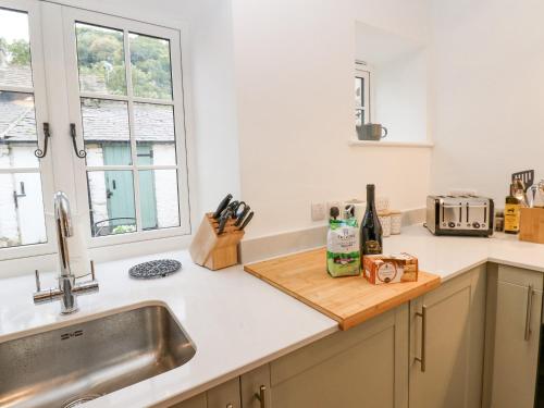 a kitchen counter with a sink and a window at Bay Tree Cottage in Richmond