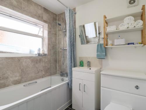 a bathroom with a bath tub and a sink and a bath tub at 160 Canterbury Road in Colchester