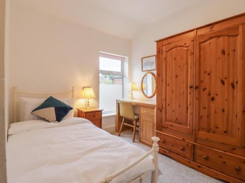 a bedroom with a bed with a dresser and a desk at 160 Canterbury Road in Colchester