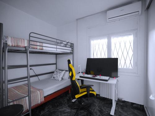 a bedroom with a desk and a computer and bunk beds at A+View Private Terrace Private Pool Family Fun in Badalona