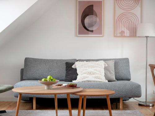 a living room with a couch and a table at Sanders Saint - Loft One-Bedroom Apartment By the Charming Canals in Copenhagen