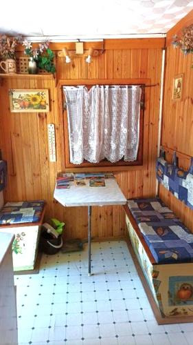 a small room with two beds and a window at Old cottage, steep hill, read info and rating in Rozdrojovice