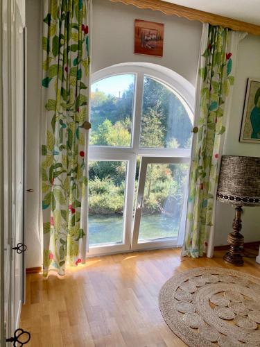 an open door with a large window in a room at Sokograd Attic in Šipovo