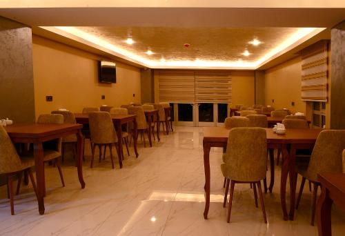 a dining room with tables and chairs in a room at ANKUVA HOTEL in Ankara