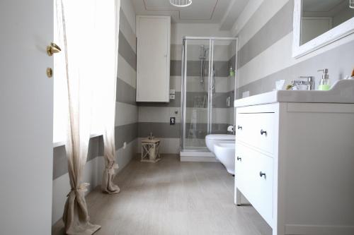 a bathroom with a white sink and a shower at La Vecchia Tenenza B&B in Città della Pieve