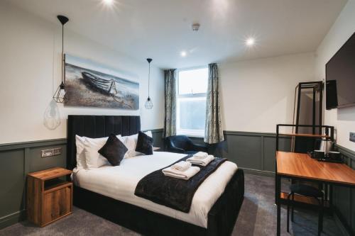 a hotel room with a bed and a desk and a desk at The Royal Bar & Shaker in Morecambe