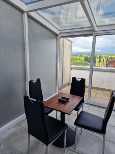 a table and chairs in a room with a window at Mountain view apartment in Cressier near Murten 