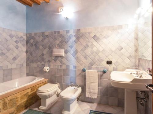 a bathroom with a toilet and a sink and a tub at La Casa Di Bice in Asciano