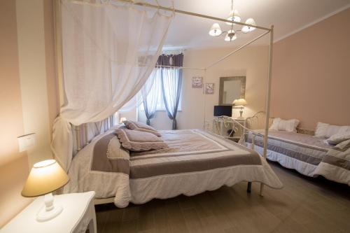 a bedroom with two beds and a large mirror at La Vecchia Tenenza B&B in Città della Pieve