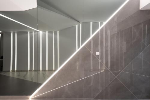 a hallway with a wall with a light on it at The Edge - Luxury Residences in Athens