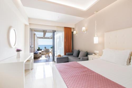 a bedroom with a bed and a living room at Agios Gordios Beach Resort in Agios Gordios