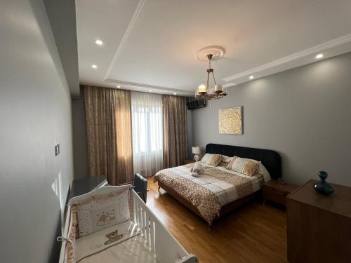a bedroom with a bed and a staircase in it at Cozy & Spacious Apartment in Baku