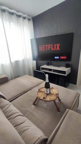 a living room with two beds and a tv at Apartamento calmo e aconchegante in Florianópolis
