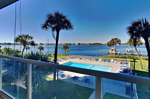 a balcony with a view of the water and a swimming pool at Sabine Yacht & Racquet #2B in Pensacola Beach