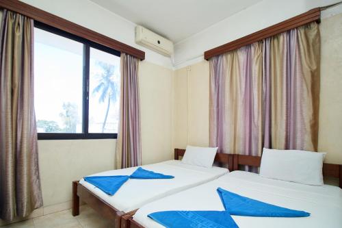 Postel nebo postele na pokoji v ubytování Mombasa Railway Gardens Hotel