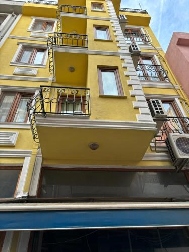 un edificio giallo con balconi sul lato di Efe Can Apart Otel a Çanakkale