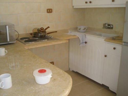 a kitchen with a counter with a sink and a stove at Dream Away Luxor in Al Marīs